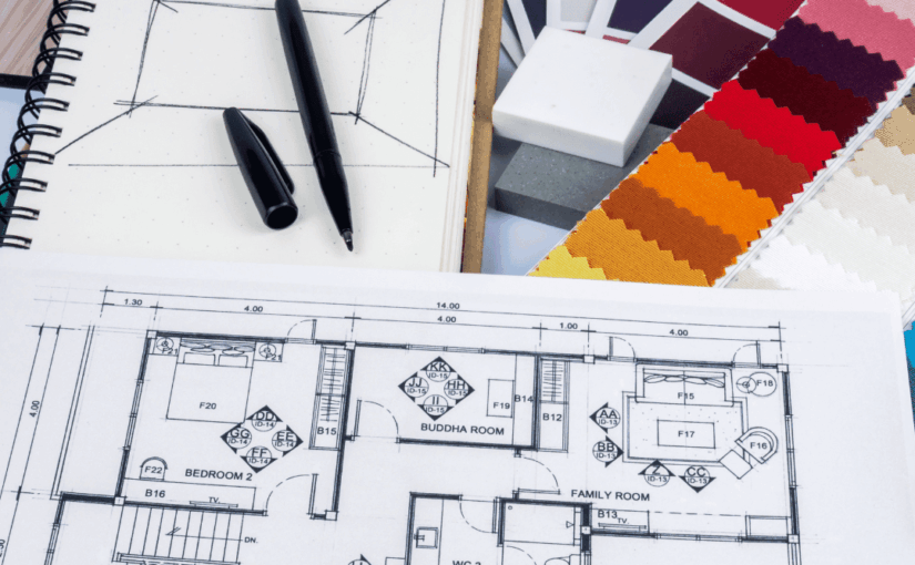 Interior design workspace with architectural floor plan, color swatches, sketch notebook, and black markers for home design planning