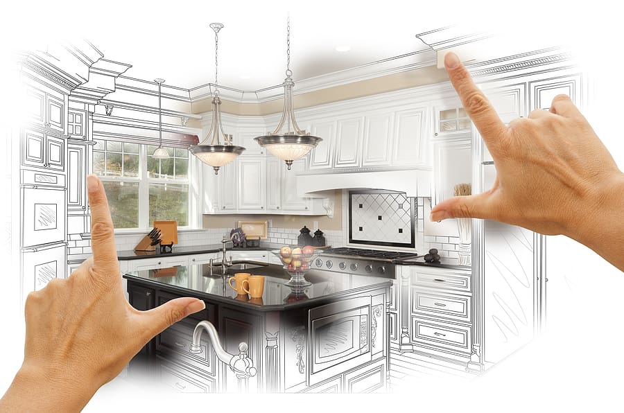 Hands framing a custom kitchen design showing sketch and rendered photo of white cabinetry, black island countertop, stainless steel appliances, pendant lighting, and subway tile backsplash